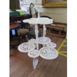 A Victorian painted cast iron three tier plant stand, in the style of Coalbrookdale, each tier