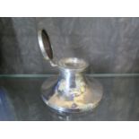 A silver capstan inkwell