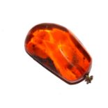 A large piece of amber, set as a pendant, 5.5cm high
