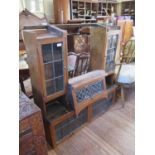 An oak and lead glazed desk top bookcase, the two glazed flaps over a centre flap flanked by a