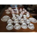 An Edwardian Wedgwood part tea service, of octagonal form with red foliate swag decoration, and a