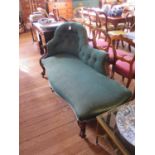 A Victorian mahogany chaise longue with button back green upholstery, shaped seat and moulded