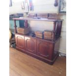 A Victorian mahogany buffet, the two tier top with fluted cabochon supports over three panelled