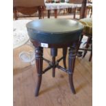 A Regency mahogany piano stool, the adjustable circular leather seat on reeded outsplayed legs, 35