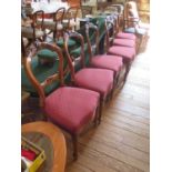 A set of six mid Victorian walnut balloon back dining chairs, with carved top and mid rails, above