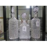 A pair of Whitefriars clear glass bark effect cylindrical decanters and stoppers, 34 cm high, and