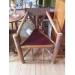 An elm turner's corner chair, the carved flat top rail and supports over a triangular seat and