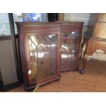 A pair of reproduction mahogany hanging corner cabinets, with glazed doors, 59 cm wide, 83 cm