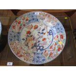 A Japanese charger, in imari colours, the centre depicting a butterfly and flowers, the rim with