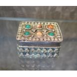 A white metal small box decorated to the lid with cabochon stones
