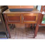 An oak and mahogany side table, with twin doors on square section legs, 74 cm wide