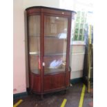 An Edwardian mahogany chequer banded bowfront display cabinet, the single door with panelled base,