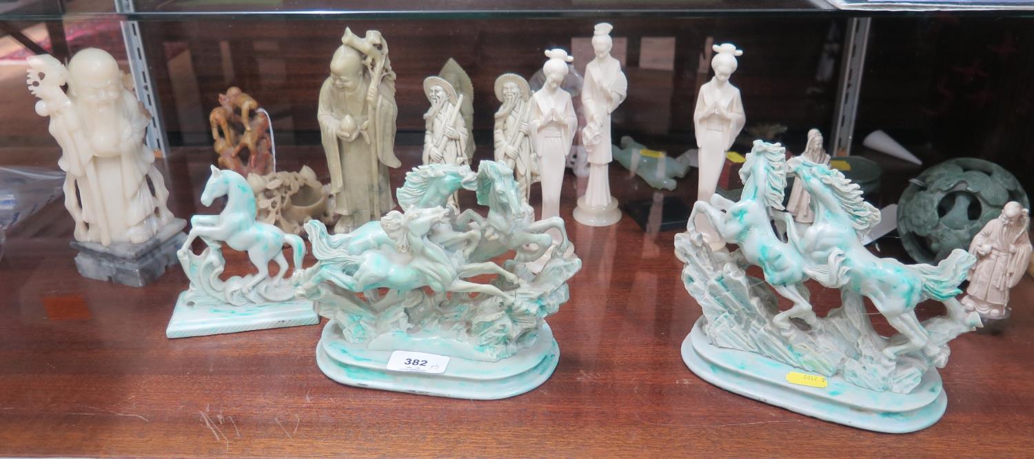 A collection of Oriental carved soapstone and resin figures including elders and horses, and a