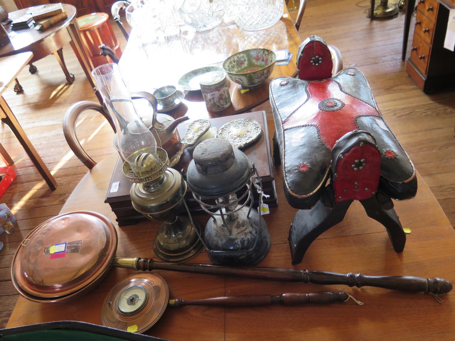 A blacked metal oil lamp, a brass oil lamp, various copperwares, a silver plated dressing table set,