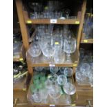 A large collection of various drinking glasses, including Stuart Crystal, branded glasses and German