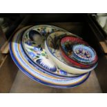 A large pottery charger with profusely hand painted decoration, 36cm diameter, another smaller and