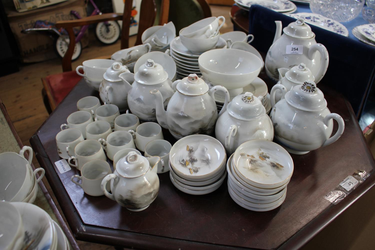 Two Japanese egg shell porcelain tea sets, each depicting Mount Fuji