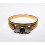 A three stone sapphire and diamond ring set in gold