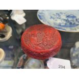 A Chinese red cinnabar lacquer box, 10cm diameter, the cover carved with children playing in a