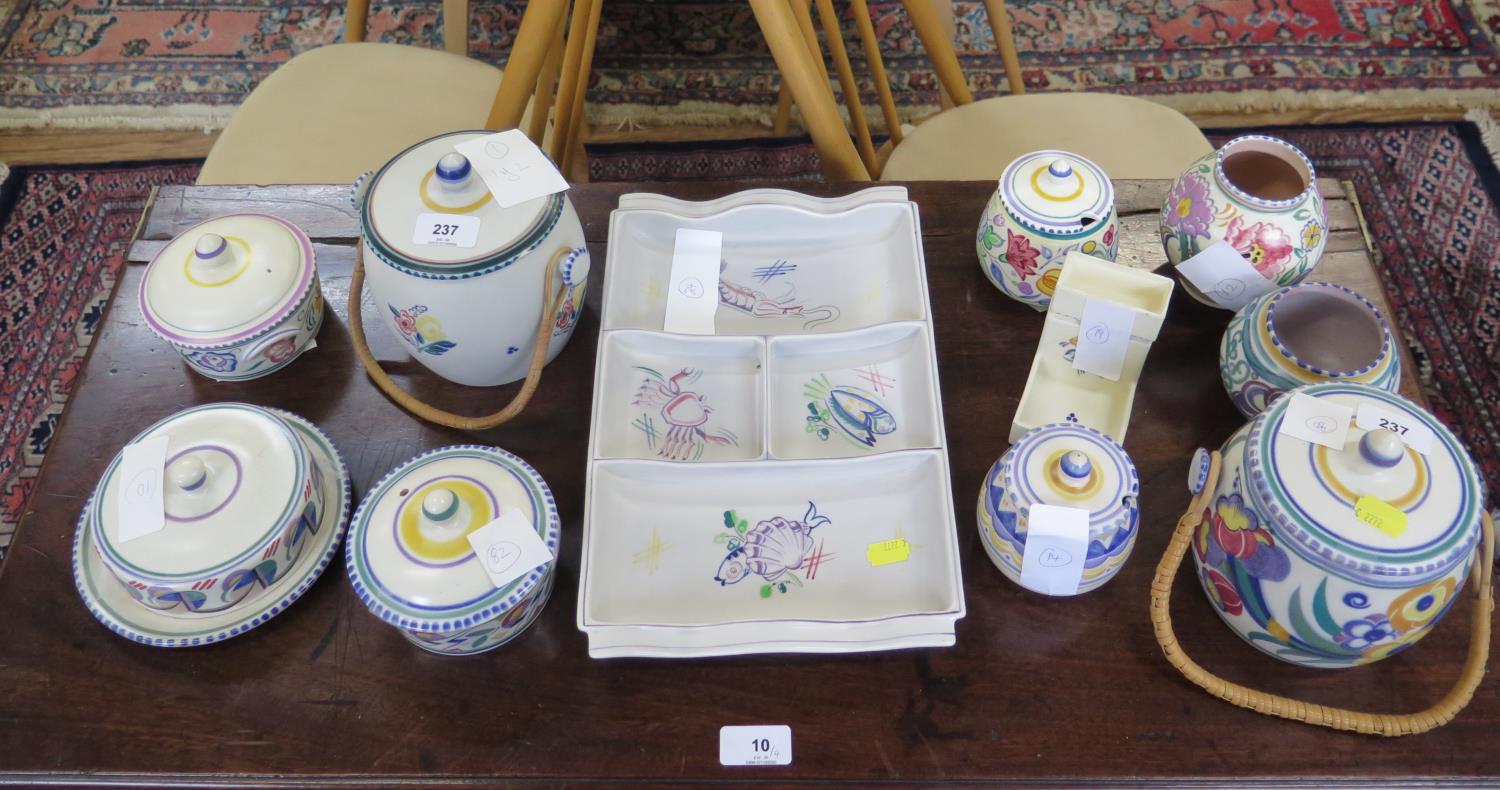 A collection of Poole Pottery, including two biscuit barrels, serving dish with seafood design, jars