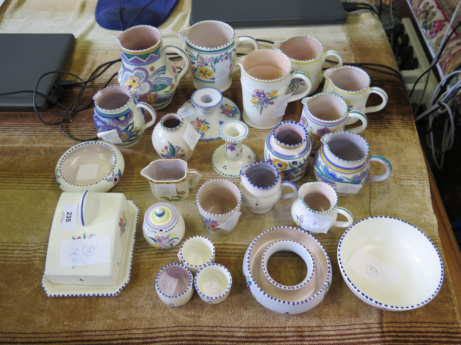 A collection of Poole Pottery, including jugs (largest 14.5 cm), covered cheese dish, candlesticks