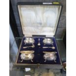 A cased set of four silver salts, with three silver spoons