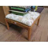 An Ercol elm Saville footstool, with concave seat rails, 59 cm square