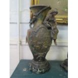 After Francois Moreau A painted spelter vase depicting a lady seated by a farming scene, on a marble