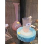Six vaseline glass plates together with a pink vaseline long necked vase and matching beaker