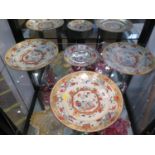 A set of three Chinese porcelain plates, with enamel decoration of a book and vase with red