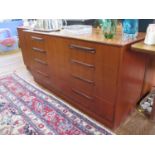 A G-Plan teak chest of drawers, with two banks of four graduated drawers on a plinth base, 140 cm