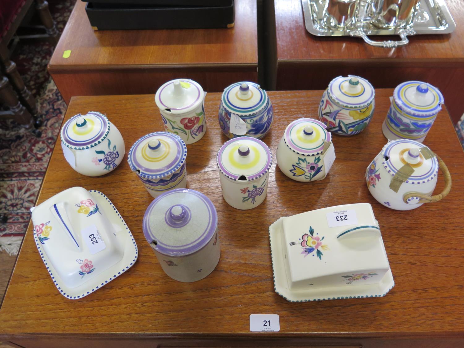Ten Poole Pottery lidded jam pots and two cheese covers, all with floral designs