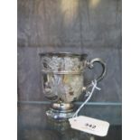 A highly decorated silver beaker on single foot