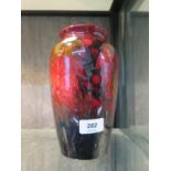 A Moorcroft Pottery grape design vase, with red glaze, signed William Moorcroft and impressed