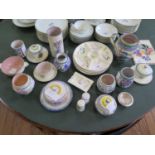 A collection of Poole Pottery, including a tile, plates, covered dishes, jars and an ashtray, all