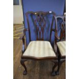 A set of five George III style mahogany dining chairs, the shaped top rails over pierced vase