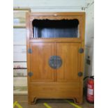 A Chinese hardwood cabinet, the open top with scroll carved frieze over of a pair of cupboard doors,