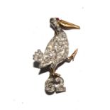 A diamond set brooch, depicting a pelican over the number 62, 28mm high