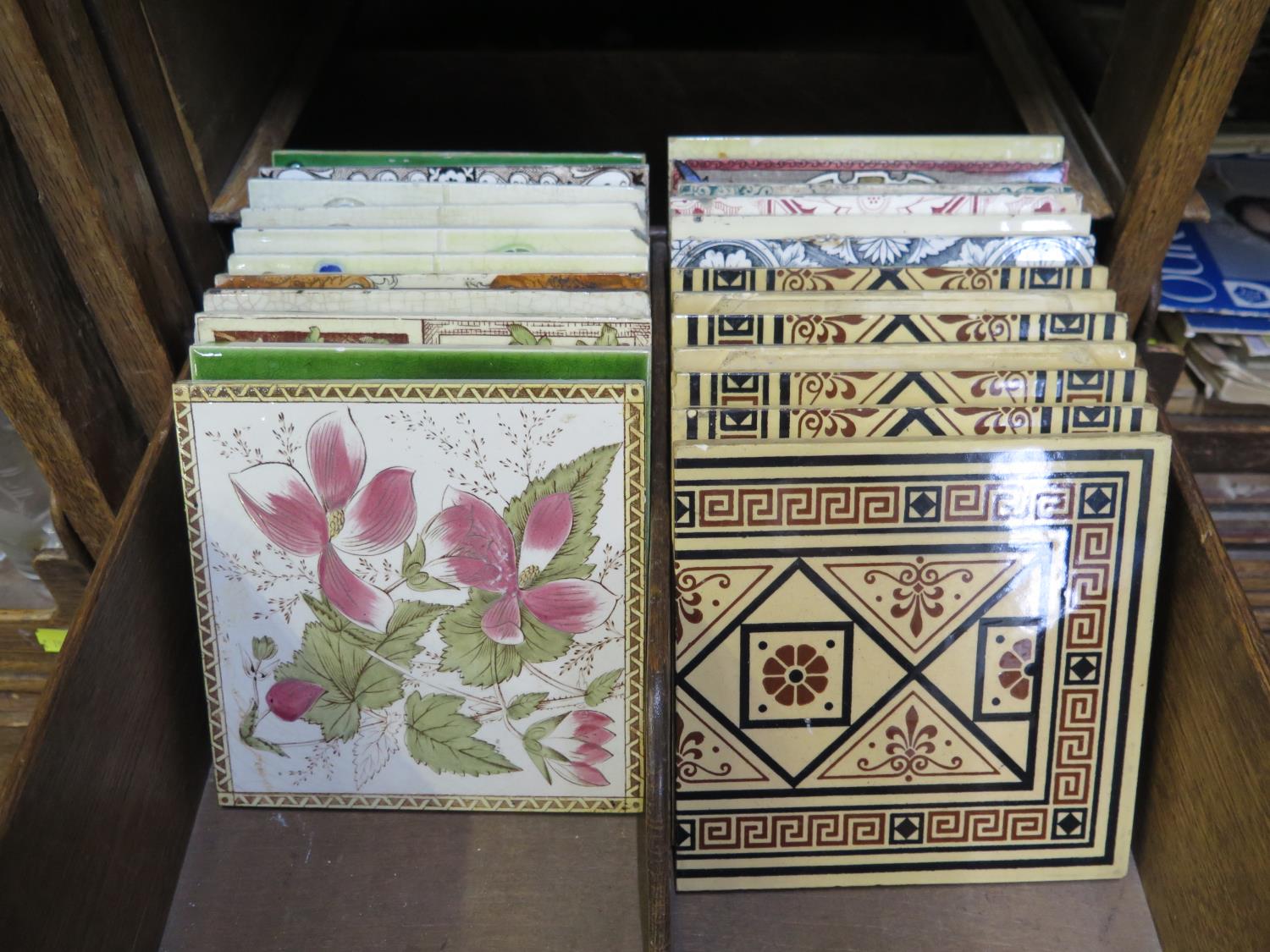A set of seven Mintons fireplace tiles, 15 cm square and seventeen other late Victorian and