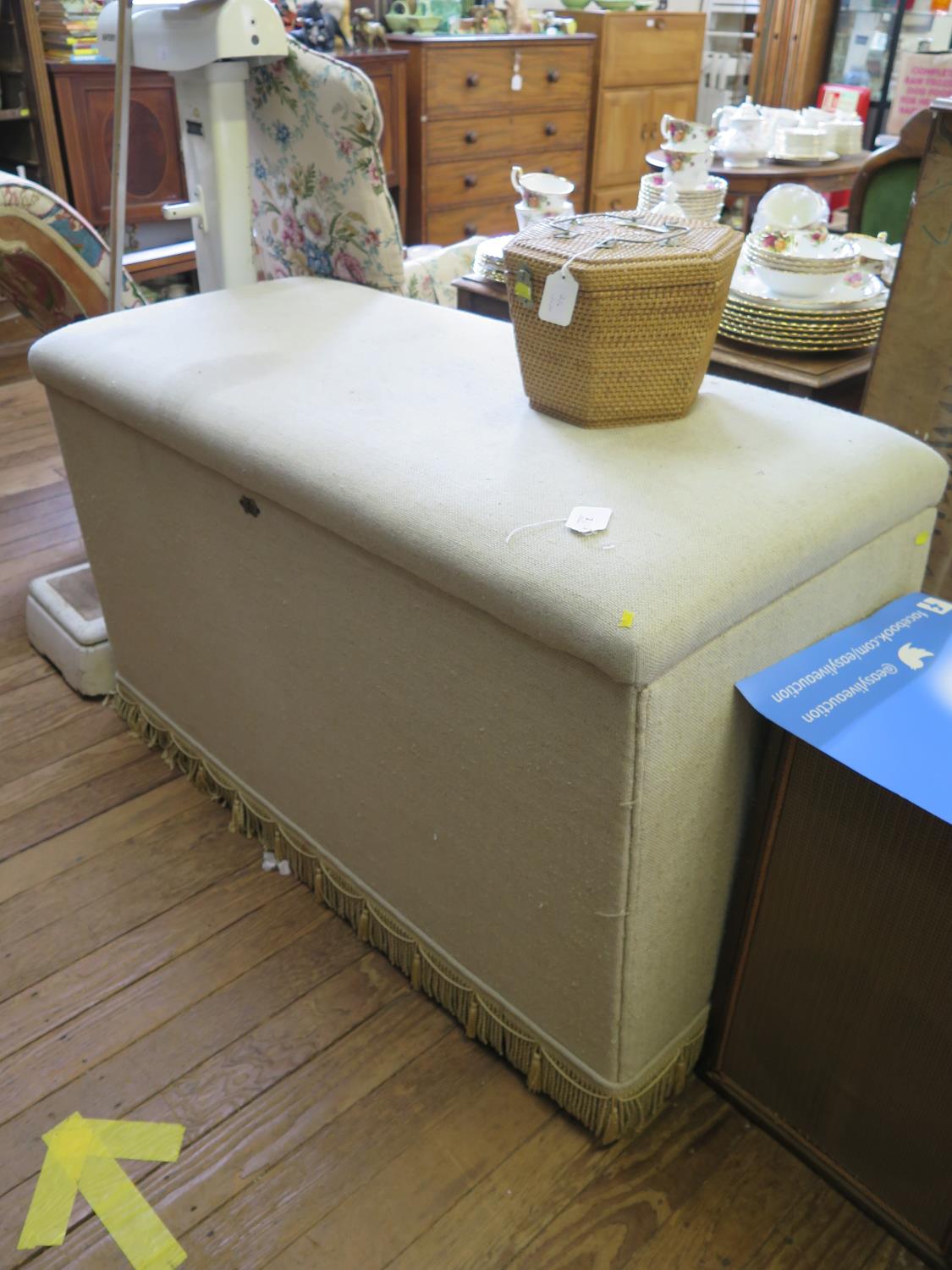 A large upholstered ottoman box, with hinged lid and later castors, 125 cm wide, 56 cm deep, 77 cm