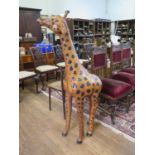 A large leather covered figure of a giraffe, with glass eyes, 143 cm high