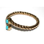 A 14 carat gold bangle set with turquoise