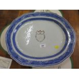 An 18th century Chinese blue and white meat plate, the central enamelled shield motif with monogram,