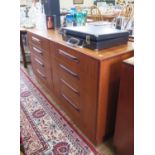 A G-Plan teak chest of drawers, with two banks of four graduated drawers on a plinth base, 140 cm