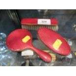 A ladies small hand mirror and brush set, enamelled in red (3)