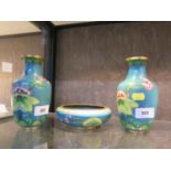 A pair of cloisonné vases and a matching bowl, with floral and crane design on a blue ground,