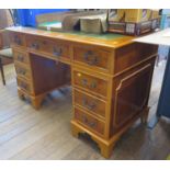 A reproduction yew wood pedestal desk, the leather inset top over three frieze drawers and pedestals