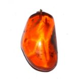 A large piece of amber, set as a pendant, 5.5cm high