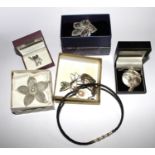 A bag containing necklaces, a bangle, brooches and pendants with mother of pearl, some silver