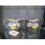 A silver cream jug and matching sugar bowl, of squat baluster form, sugar bowl 13.5 cm wide (2)